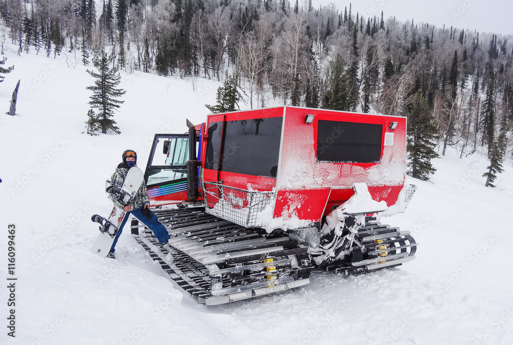 Snowboarder is loaded into the snowcat Snowboarder is loaded into the snowcat