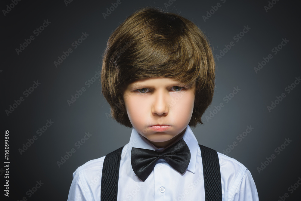 Closeup sad boy with worried stressed face expression Closeup sad boy with worried stressed face expression