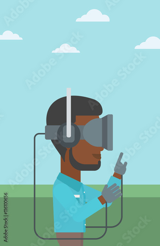 Man in virtual reality headset playing video game.