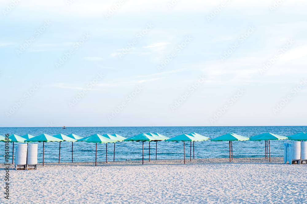 many sun umbrellas in the warm sandy beach