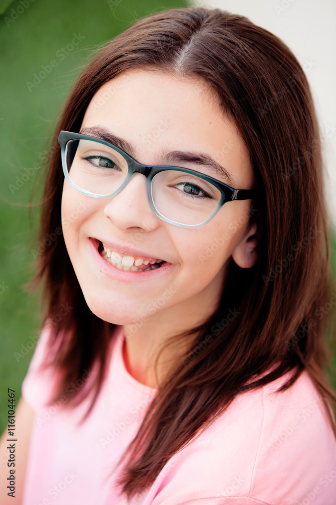 Pretty preteenager girl with glasses outside
