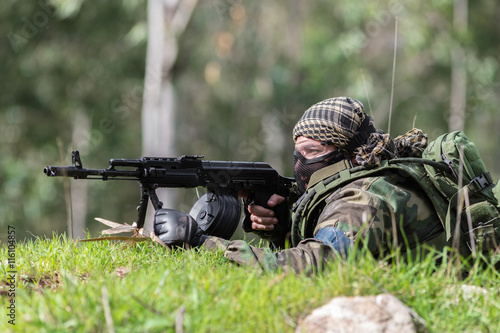 men in military uniform with weapon