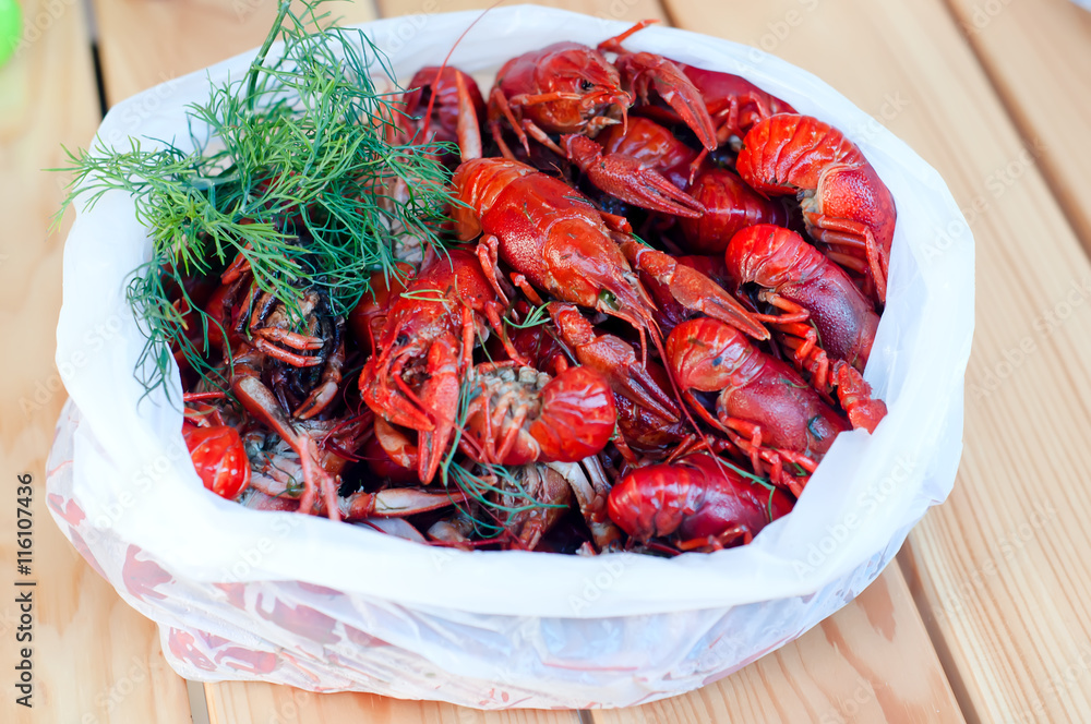 Boiled crayfishes with greenery on a plate Boiled crayfishes with greenery on a plate