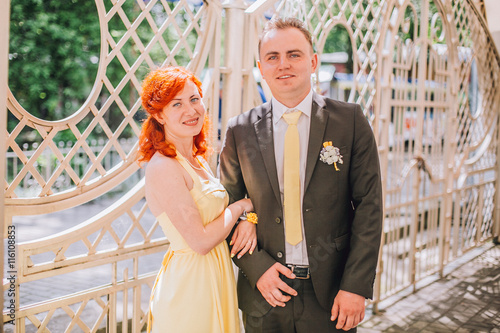 Bridesmaid and groomsman portrait in cafe. Woman with red hair.