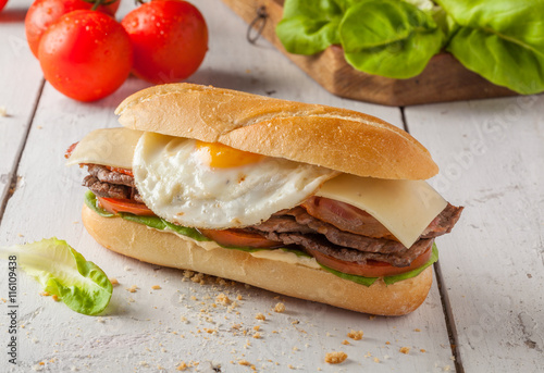 Chivito, a typical sandwich from Uruguay with beef, bacon, cheese and egg.