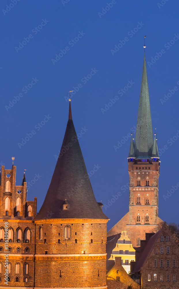 Fototapeta premium Holstein gate and Petri church by night in Lubeck
