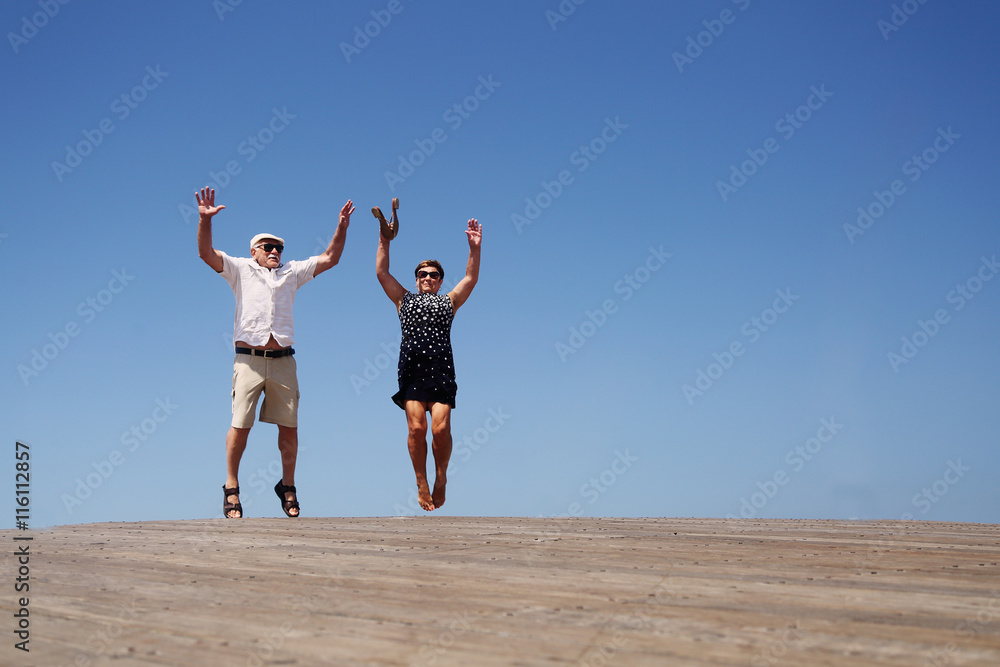 senior couple jumping senior couple jumping