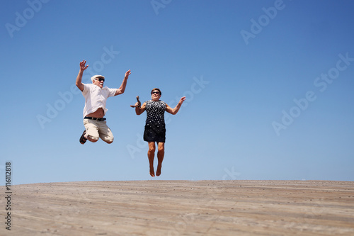 senior couple jumping