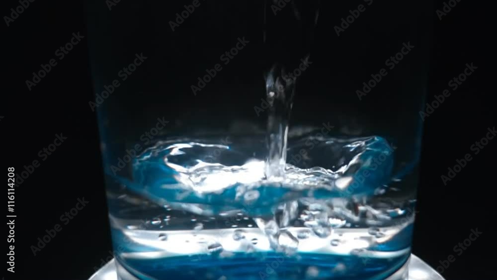 The crystal clear water is poured into a glass. Bubbles are moving and beautifully reflect light. Slow motion, high speed camera, 250fps The crystal clear water is poured into a glass. Bubbles are moving and beautifully reflect light. Slow motion, high speed camera, 250fps