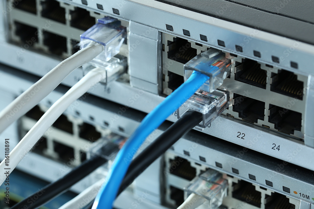 Ethernet cables connected to network switch, close up Ethernet cables connected to network switch, close up