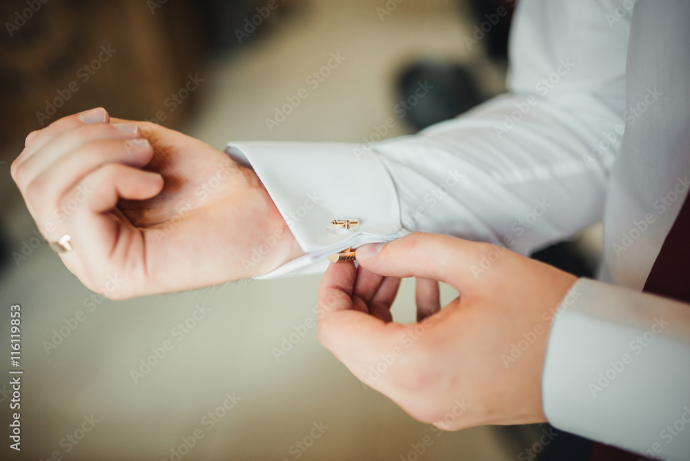 Man corrects belt, fees groom, man's hands, dressing, man buttons pants, jeans Man corrects belt, fees groom, man's hands, dressing, man buttons pants, jeans