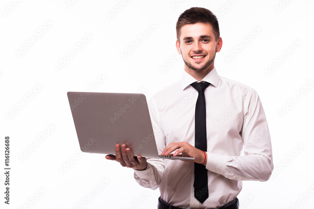 Handsome young businessman standing and using laptop over white background Handsome young businessman standing and using laptop over white background