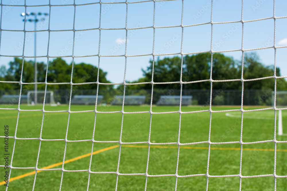 Fototapeta premium Soccer net on sports field closeup