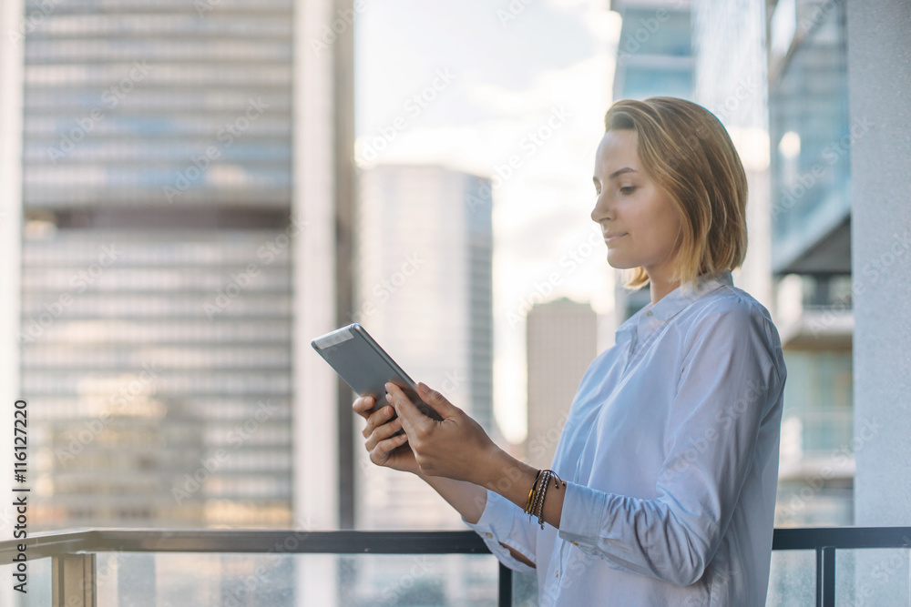 Attractive woman talking with friends by using the tablet, Professional female manager working outside. Tablet on city background, Flare light, Shallow DOF.