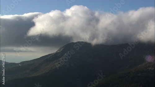 Clouds On Top Of Frost Covered Mountains photo