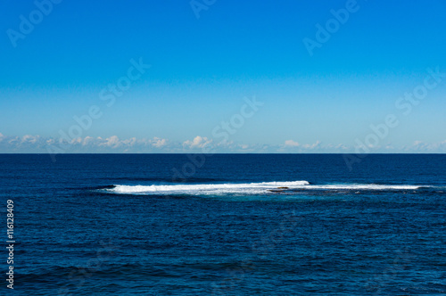 Abstract nature background of clear blue sky and calm sea with distant wave. Australia, Pacific ocean