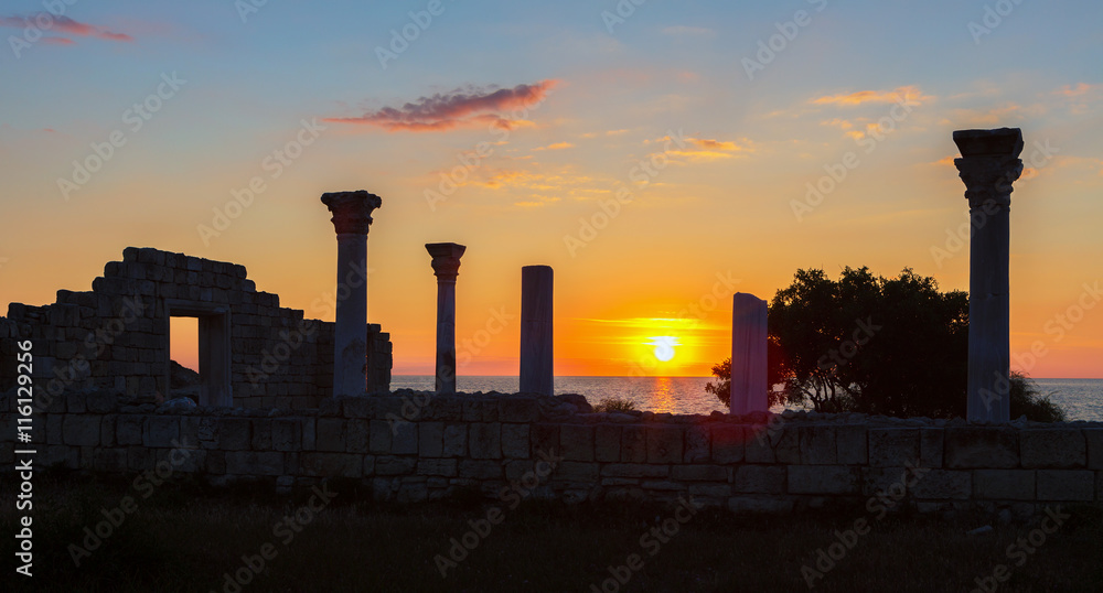 Ancient Greek basilica and marble columns in Chersonesus Taurica on the sunset background.