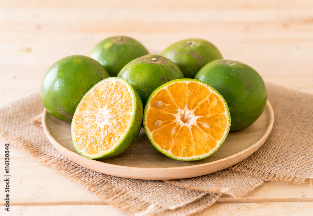 fresh orange on wood plate fresh orange on wood plate