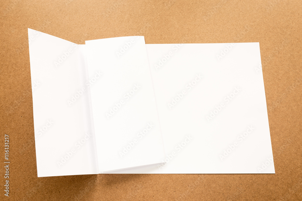 Fototapeta premium White paper note on business wood desk with copy space.
