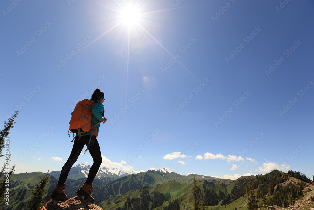 successful young woman hiker enjoy the view on mountain peak