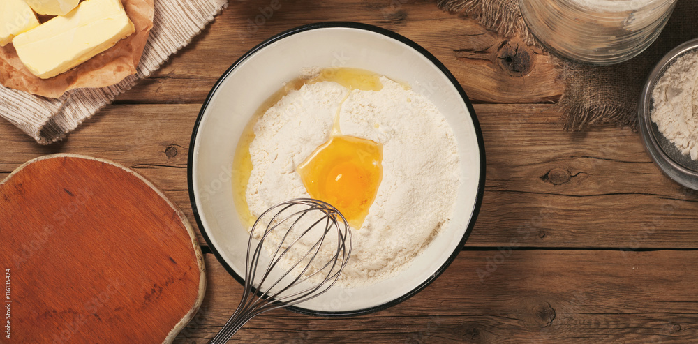 Flour in a bowl with egg yolk Flour in a bowl with egg yolk