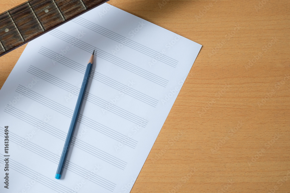 Music paper with pencil and neck of guitar. wooden background. Music paper with pencil and neck of guitar. wooden background.