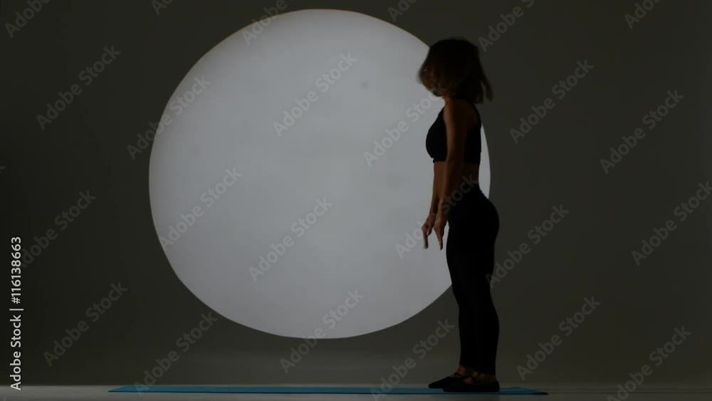 Gymnast stands with the posture of the bridge. Back light. Silhouette Gymnast stands with the posture of the bridge. Back light. Silhouette
