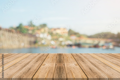 Wooden board empty table in front of blurred background. Perspective brown wood over blur wooden bridge - can be used mock up for display or montage your products. spring season. vintage filtered. © tirachard