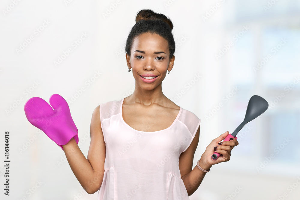 African american woman holding kitchen utensils African american woman holding kitchen utensils