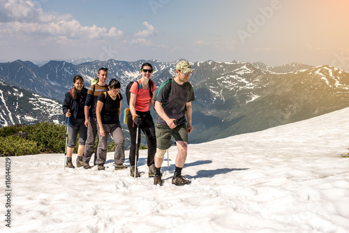 hikers go in groups through the snow