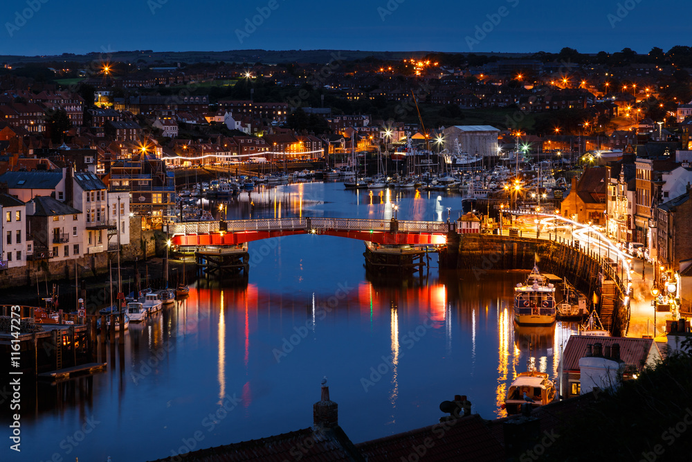 WHITBY, ENGLAND - JULY 16: The swing bridge within Whitby harbour, at night. In Whitby, North Yorkshire, England. On 16th July 2016.