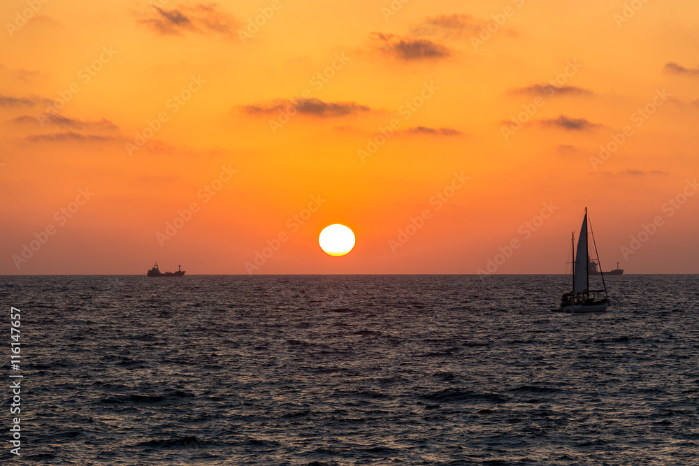 yellow-red sunset on the sea with views of the sailboat