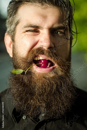 bearded man with red cherry