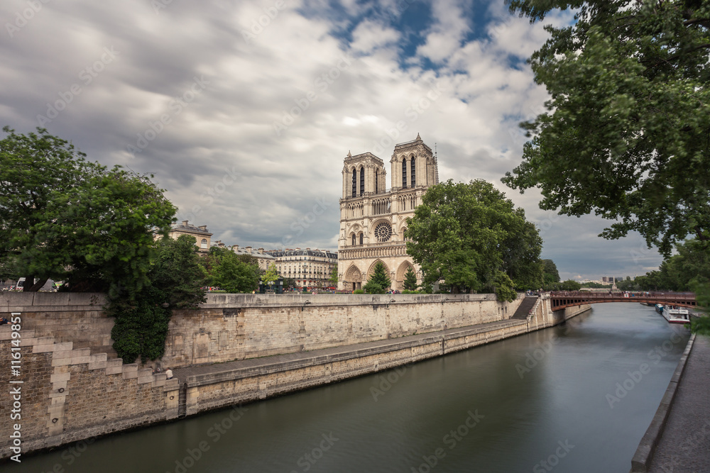 Notre Dame de Paris. France. Ancient catholic cathedral on the quay of a river Seine. Famous touristic architecture landmark in summer
