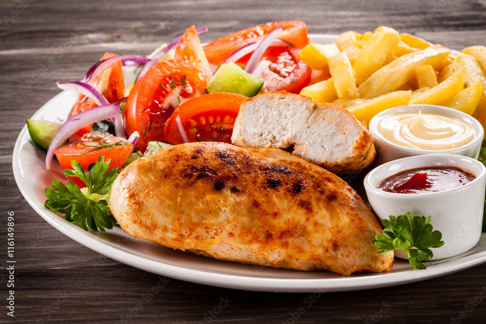Fried chicken fillet, chips and vegetable salad Fried chicken fillet, chips and vegetable salad