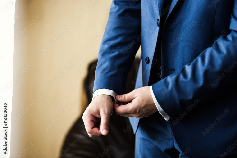 Businessman wears a jacket. Sharp dressed fashionist wearing jac