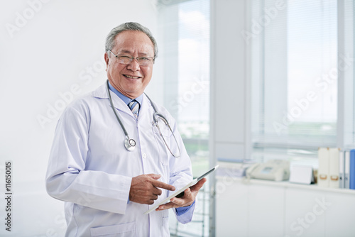 Portrait of smiling Vietnamese doctor working in hospital