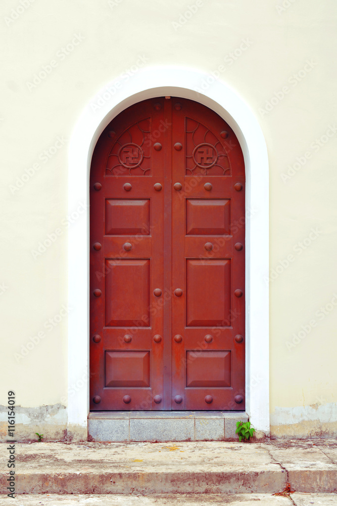 Fototapeta premium red iron door with swastika symbol at Kek Lok Si chinese temple in Penang.