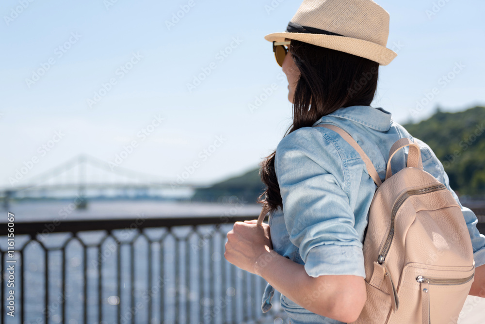 Beautiful delighted woman standing near river