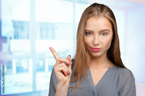 Free Download smiling young woman pointing - GFXLoad