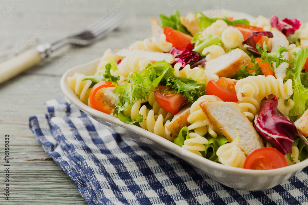 Noodle salad with green lettuce, tomatoes and roasted chicken. Noodle salad with green lettuce, tomatoes and roasted chicken.