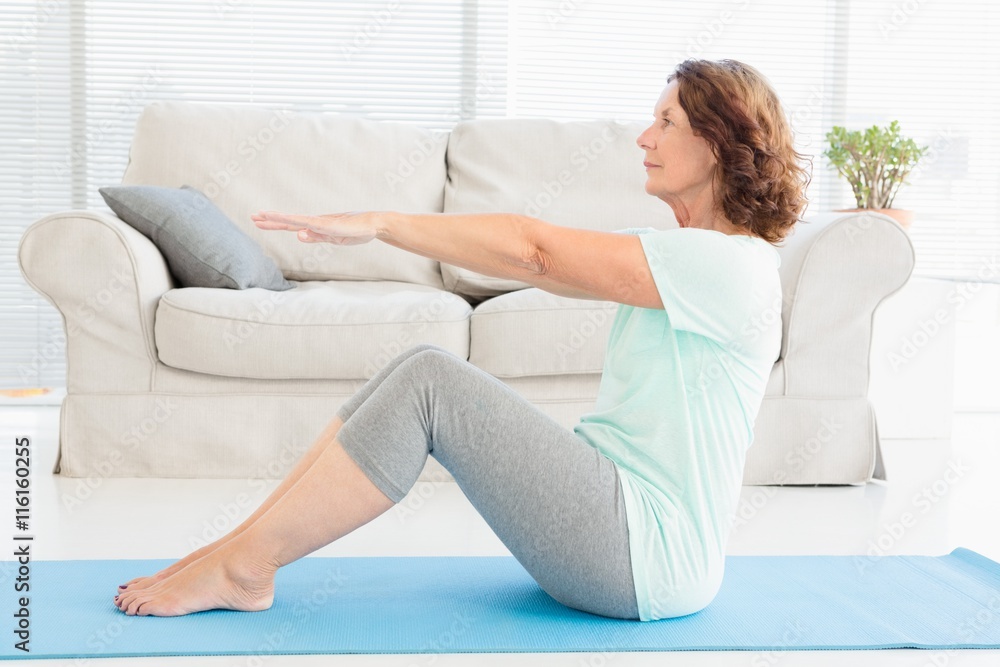 Fotografie Mature woman doing stretching exercise