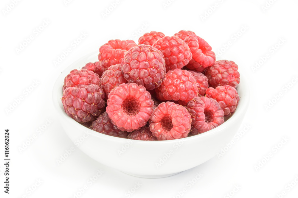 raspberry fruits at white ceramic cup isolated on background raspberry fruits at white ceramic cup isolated on background