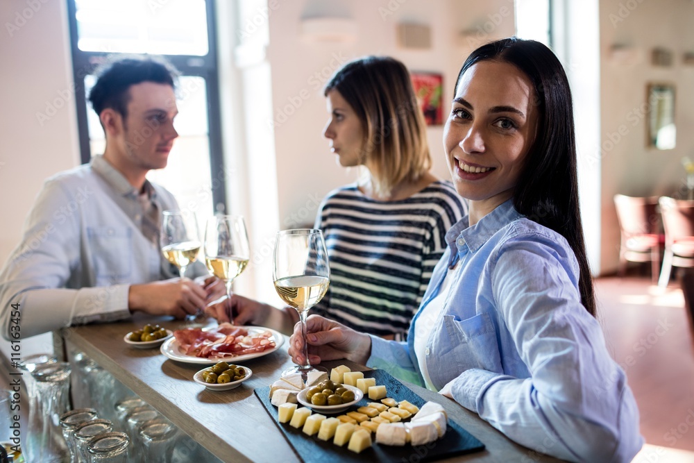 Woman having food with friends at bar counter
