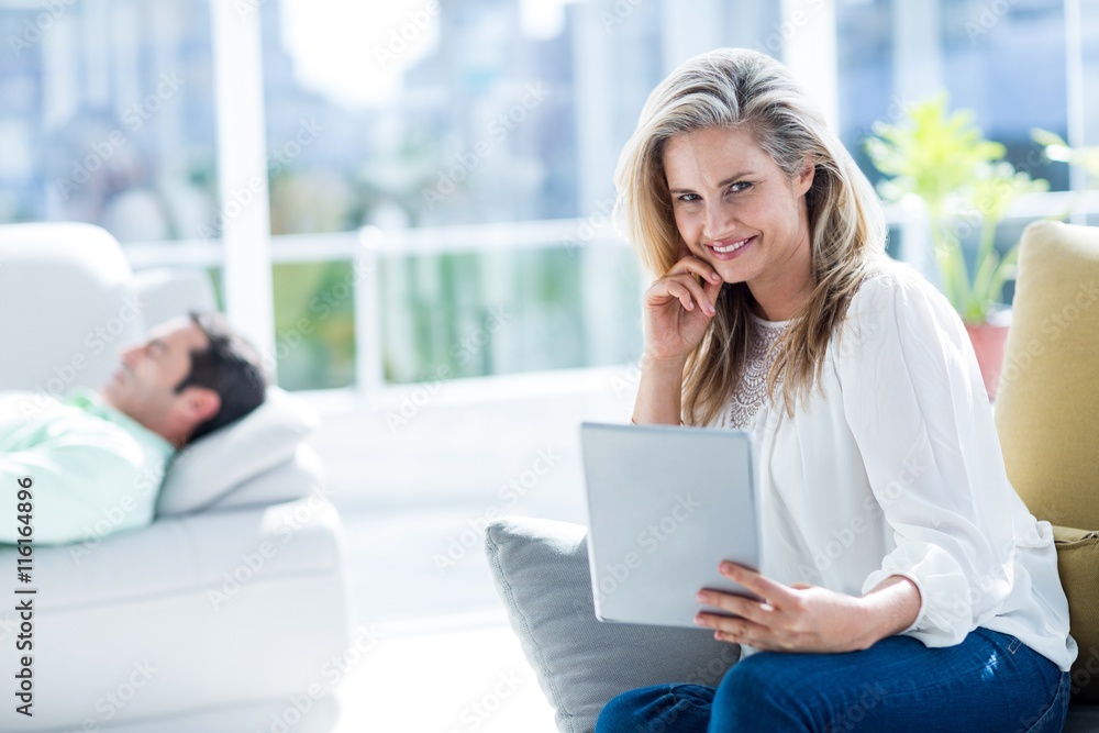 Smiling woman holding digital tablet at home Smiling woman holding digital tablet at home