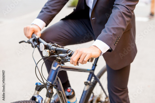 Successful businessman riding bicycle