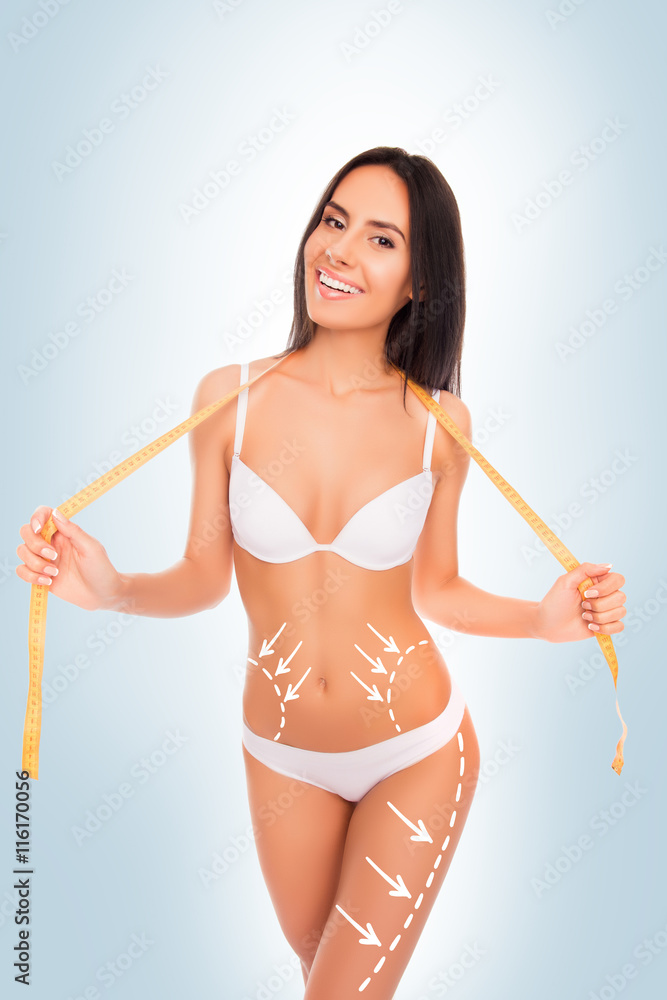 Cheerful happy slim brunette with perfect figure posing with m Cheerful happy slim brunette with perfect figure posing with m