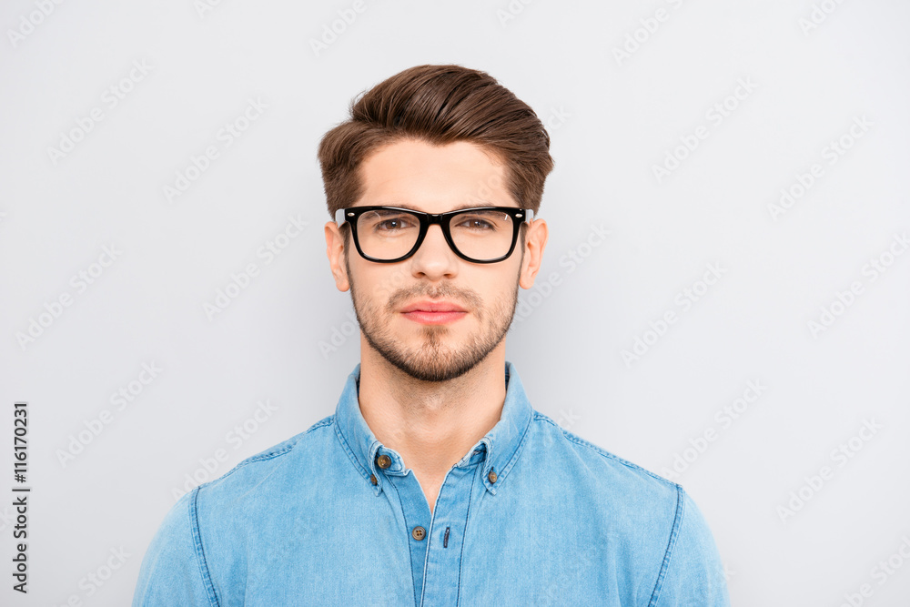 Portrait of serious calm minded businessman wearing glasses
