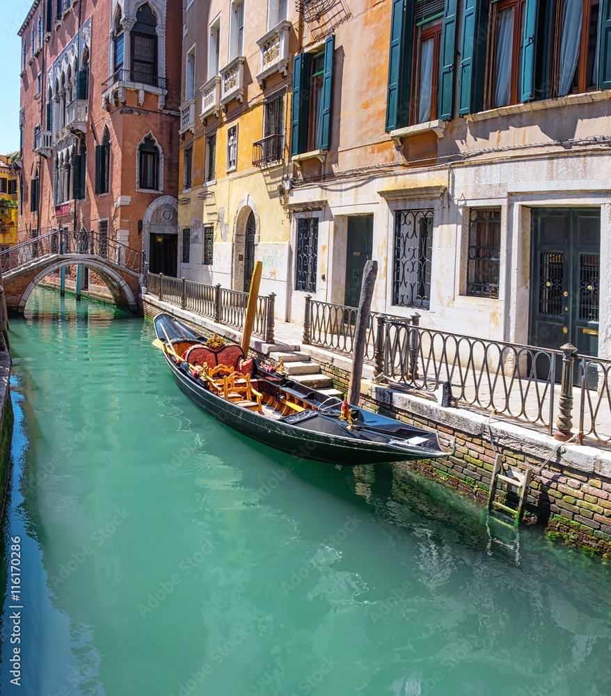 Gondola, old buildings and bridge in central Venice