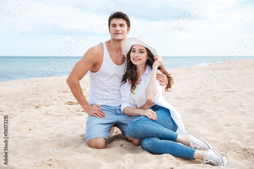 Beautiful couple sitting on the beach